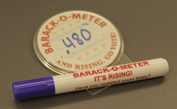 a button and marker with Barack-O-Meter printed on them